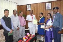 Presenting  Hon'ble Governor Shri Indrasena Reddy Nallu with sticker flag of Tripura bharat scouts & Guide